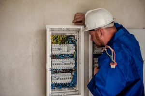 Electrician looking at panel